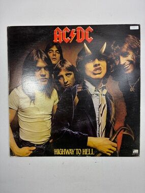 AC/DC album cover with red logo and black, brown tones